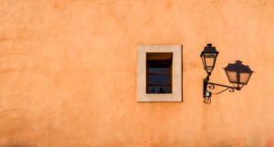 Old street lamp and window with shadows in Coursan Old street lamp and window with shadows in Coursan